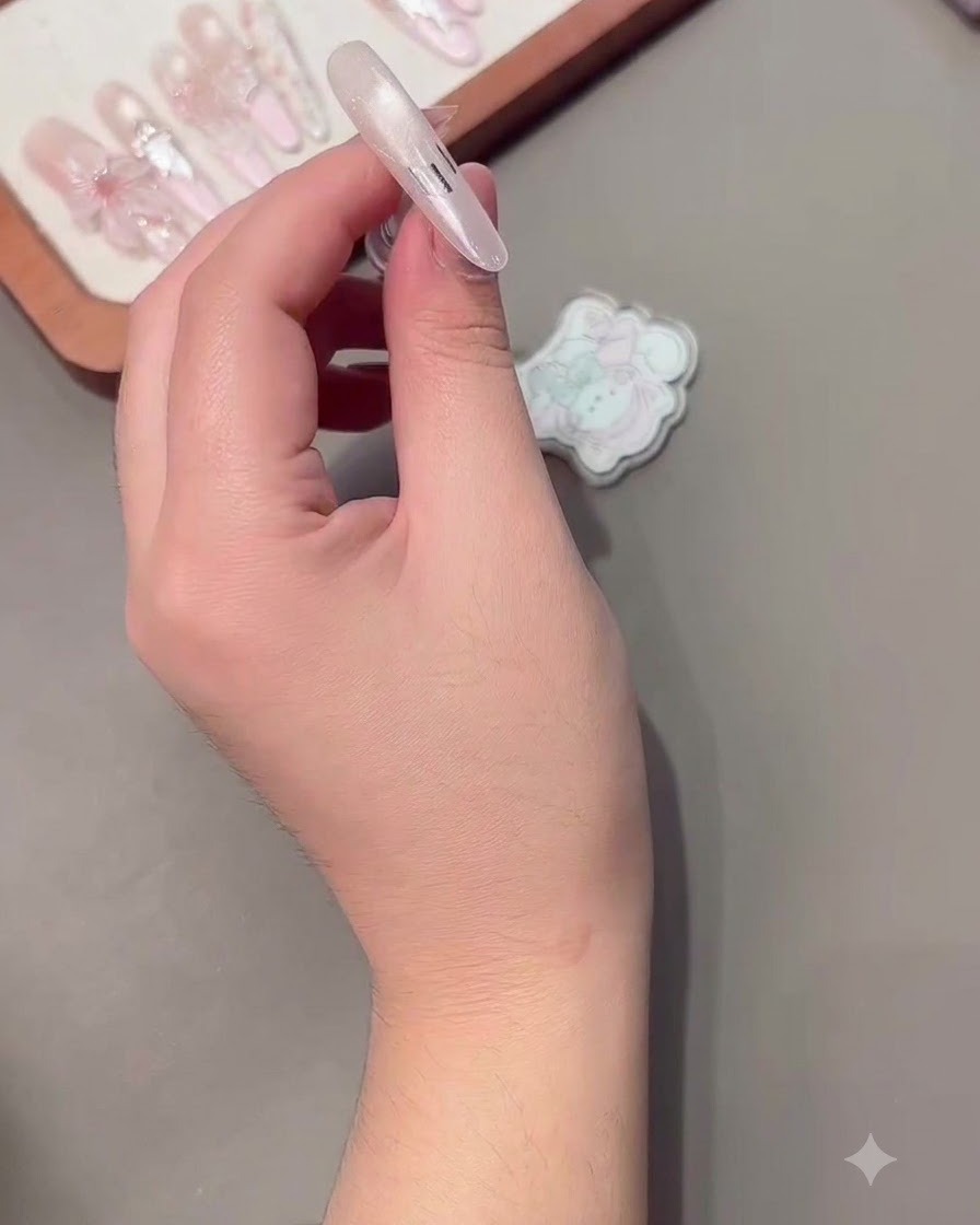 A French guideline sticker placed neatly on a nail surface.