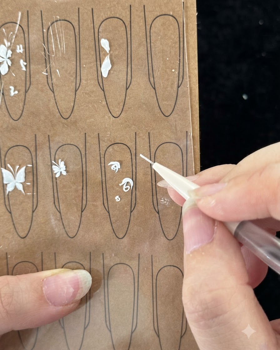 A close-up view of the brush painting the second stroke from the inside to wrap around the rose center.