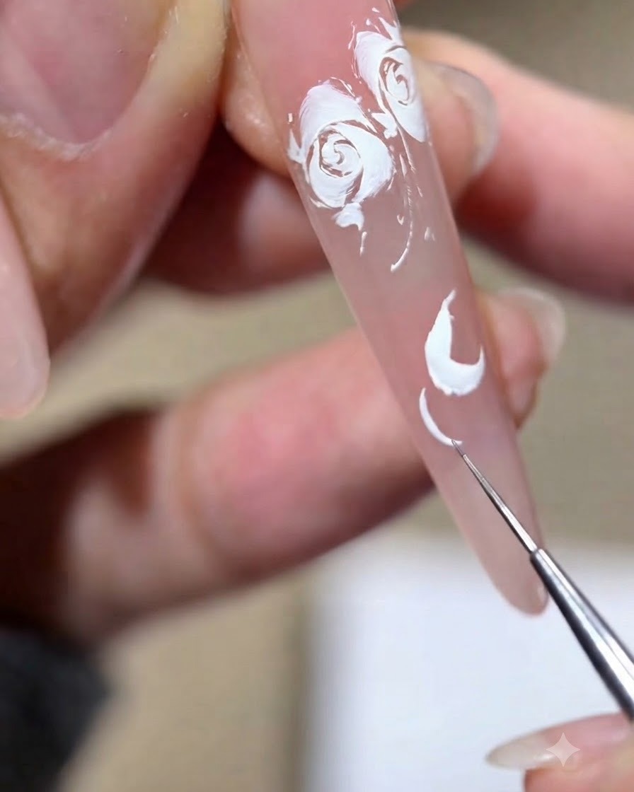 A fine liner brush dragging out the fine edges of a painted white rose petal.