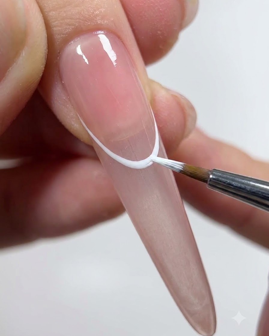 A liner brush carefully painting a half-wrapping curve for the third petal.