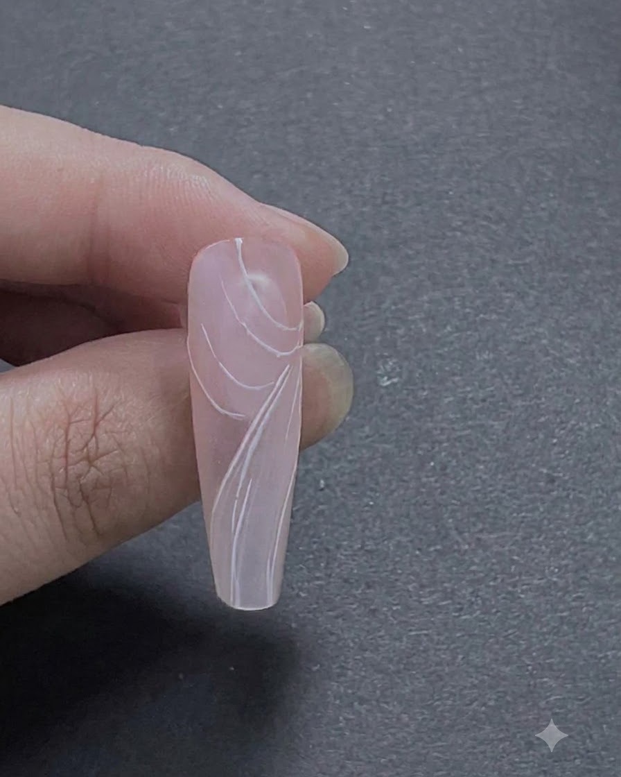 A completed view of multiple layered white rose petal strokes forming a detailed floral arrangement on the nail.