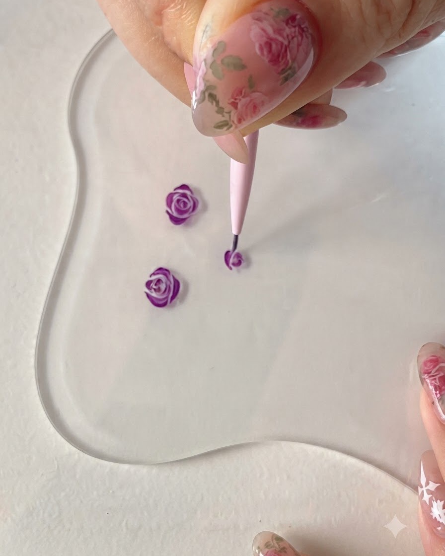 A fine liner brush adding sweeping outer petal lines to further develop the purple rose shape.