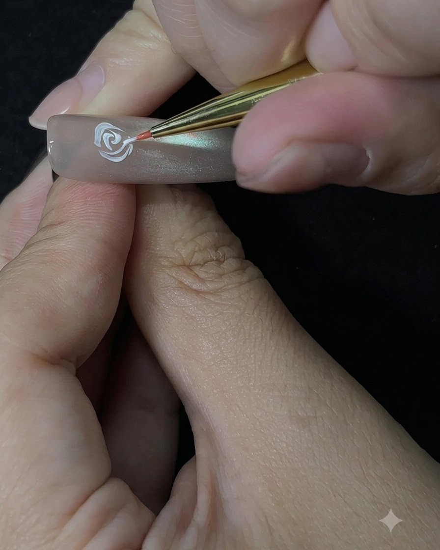 A detail brush building outer rose petals using a dabbing motion on the nail.