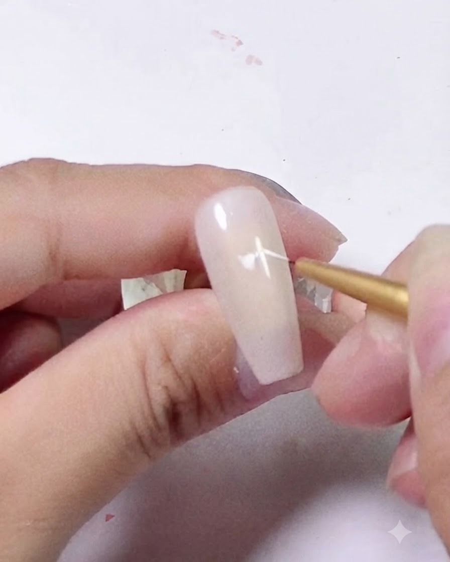 A close-up of a liner brush adding curved white brush strokes around the center dot.