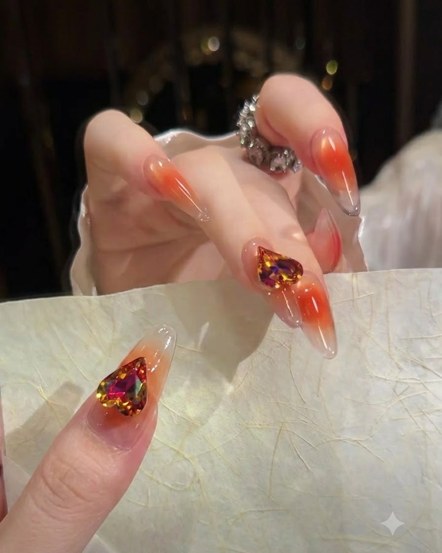 An index fingernail showcasing a soft gradient from a clear cuticle base to a translucent orange tip.
