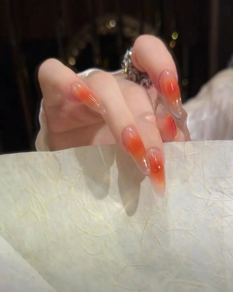 A side angle view of sculpted gel nails showing a smooth, high-gloss surface and clean arch profile.
