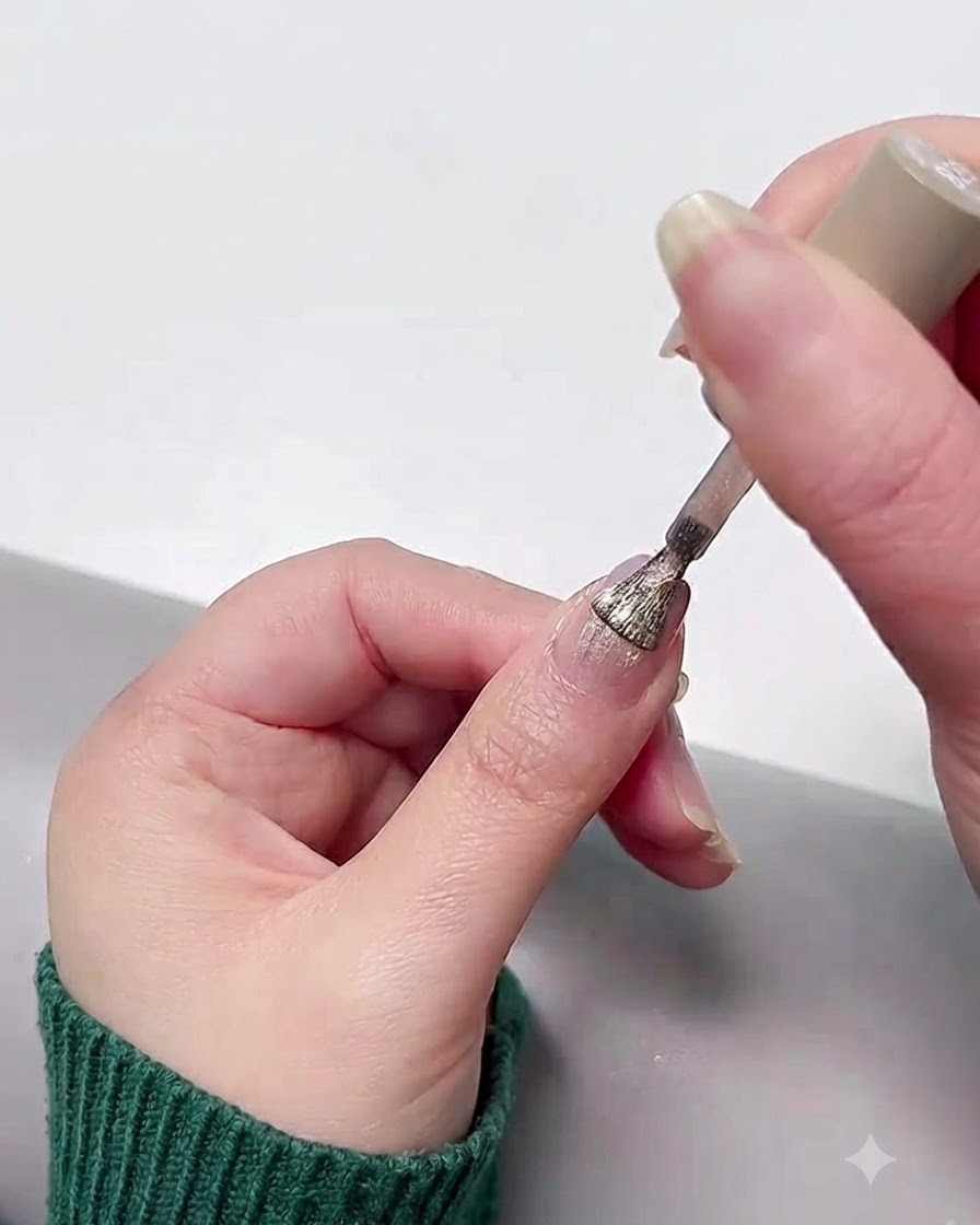 Applying a sparkly cat eye gel coat over the cured gradient base.