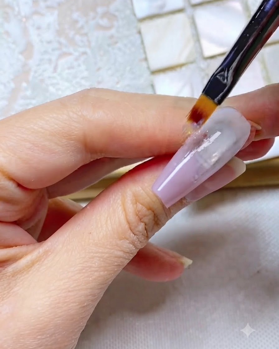 An ombre brush pulling grey-purple gel straight down the length of the nail, creating a streaky appearance.