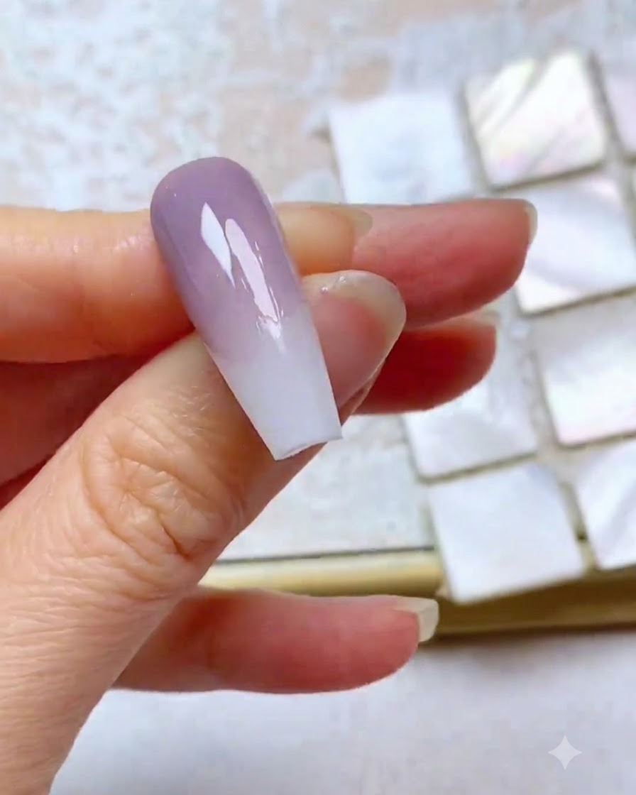 A nail showing a blended third layer of purple gel with a neat top edge.