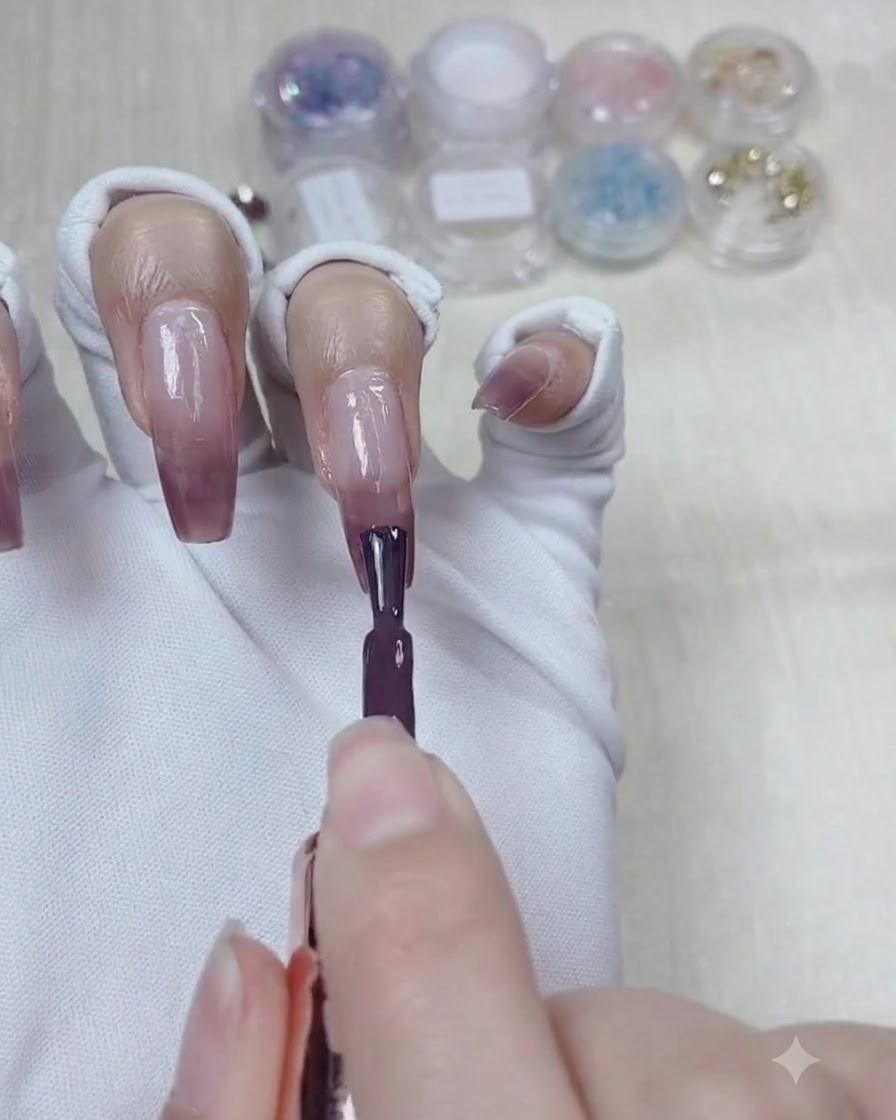 Applying a third layer of deeper taro purple gel to the top third of the nail.