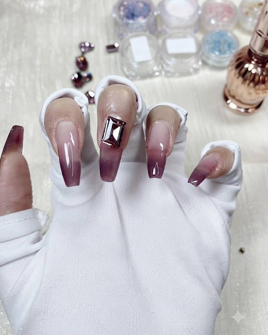 A rectangular crystal gem placed on the center of a taro purple gradient nail for design comparison.