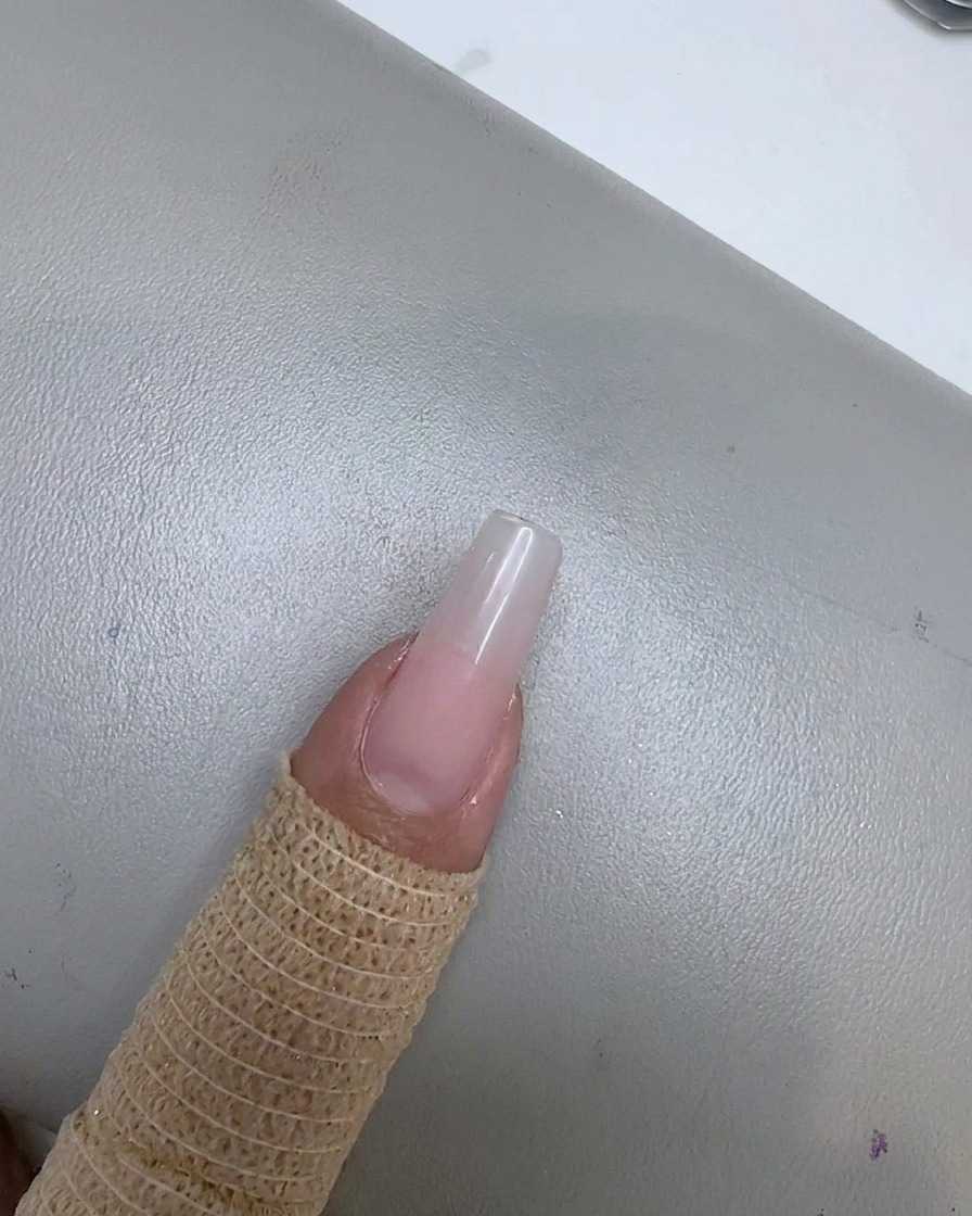 A nail with a soft bean paste pink gradient effect fading toward the cuticle area.