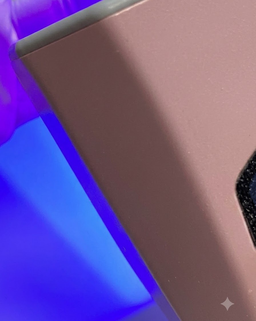 A sponge buffer block smoothing the surface texture of a manicured nail.