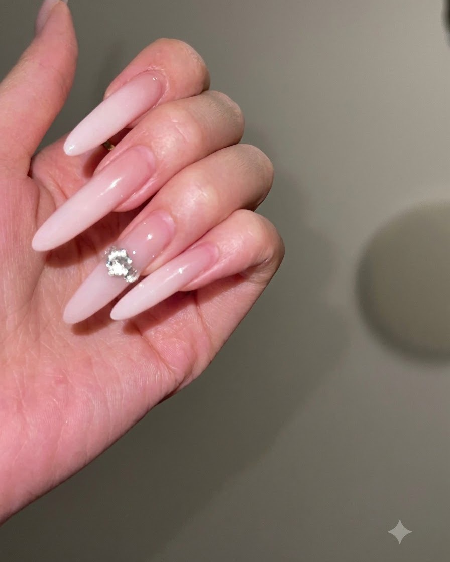 A nail file shaping and slimming the side edges of a long stiletto nail.