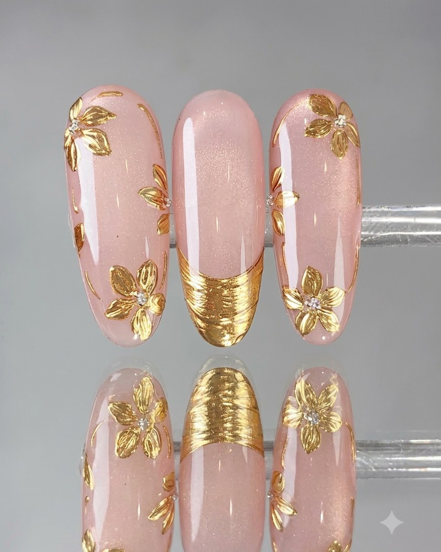 A fine brush applying powder-sealing top coat over a gold French tip nail design.