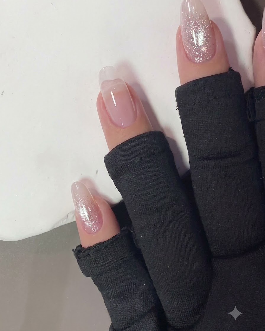 Nails curing under a compact UV/LED lamp light.