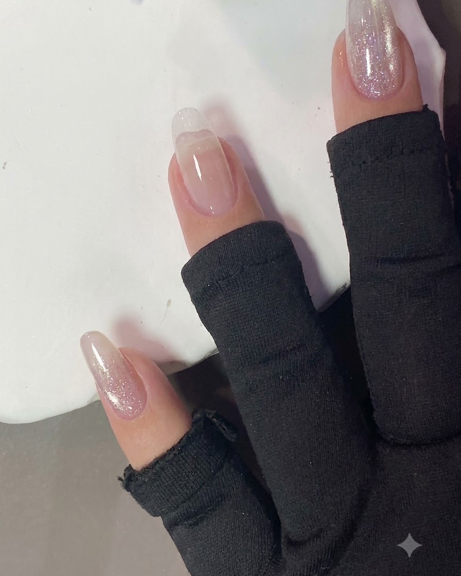 A cotton pad wiping the surface of a cured nail.