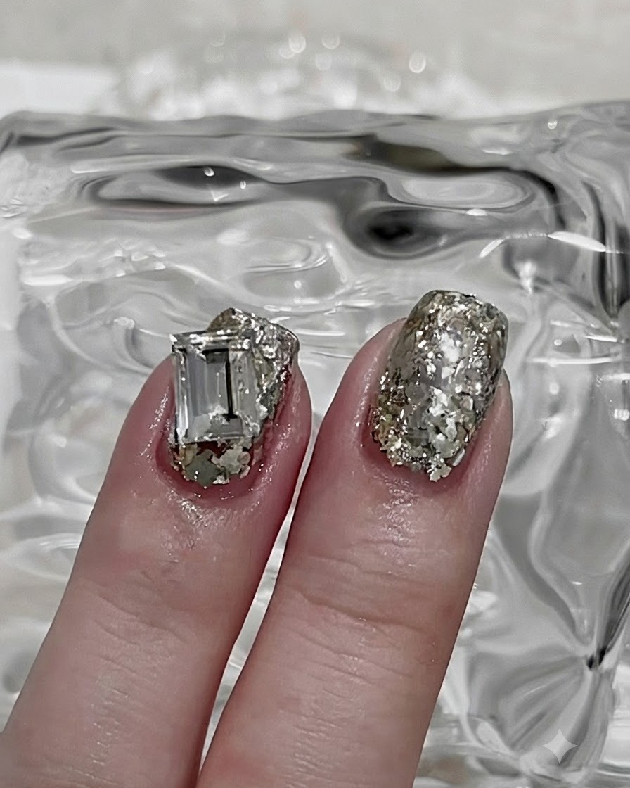 A hand with base coat applied placed inside a UV nail curing lamp.