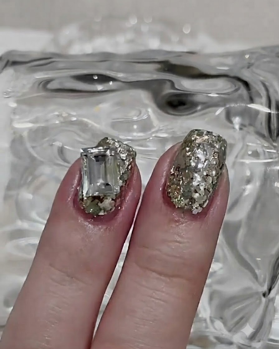 A detailed shot of sparkling silver glitter powder being meticulously applied over a sticky gel nail layer.