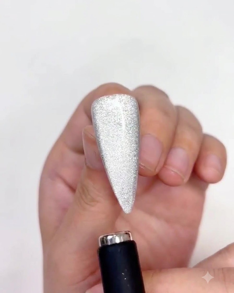A magnet guiding the magnetic particles upward on the nail surface.