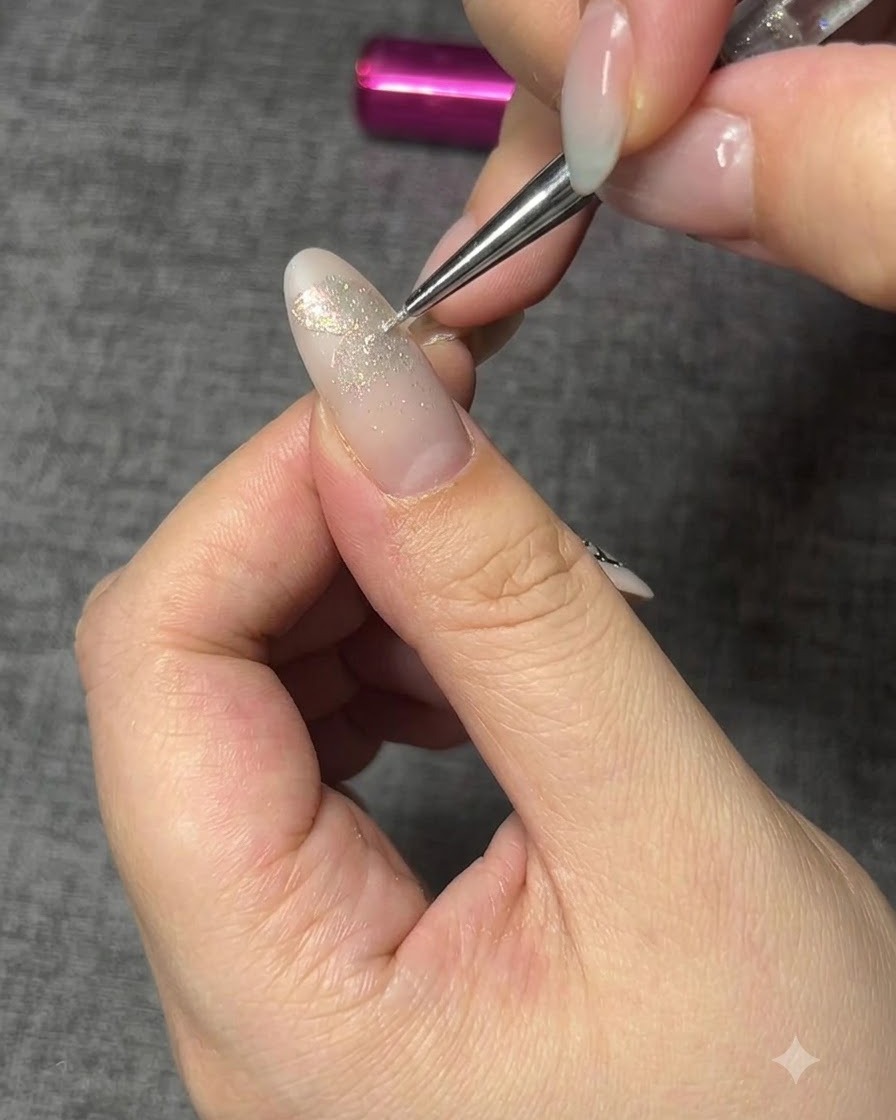 An applicator brush dusting aurora powder over the cured butterfly base shape.