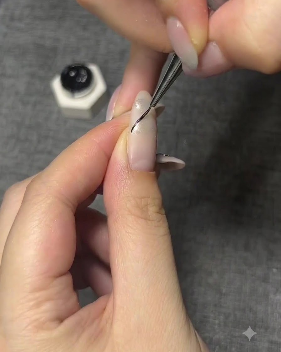 A fine brush drawing a thin black curved outline for a butterfly wing on a manicured nail.