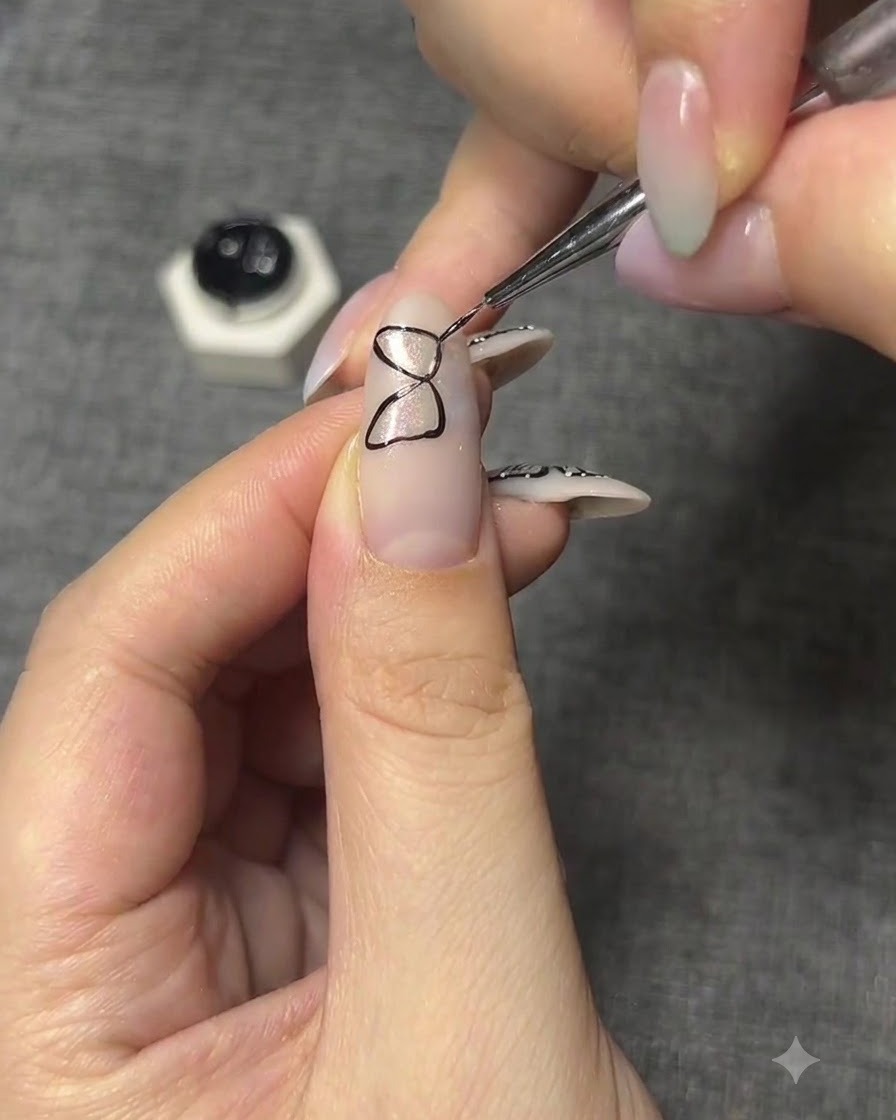 A nail featuring a completed geometric black outline of a butterfly wing structure.