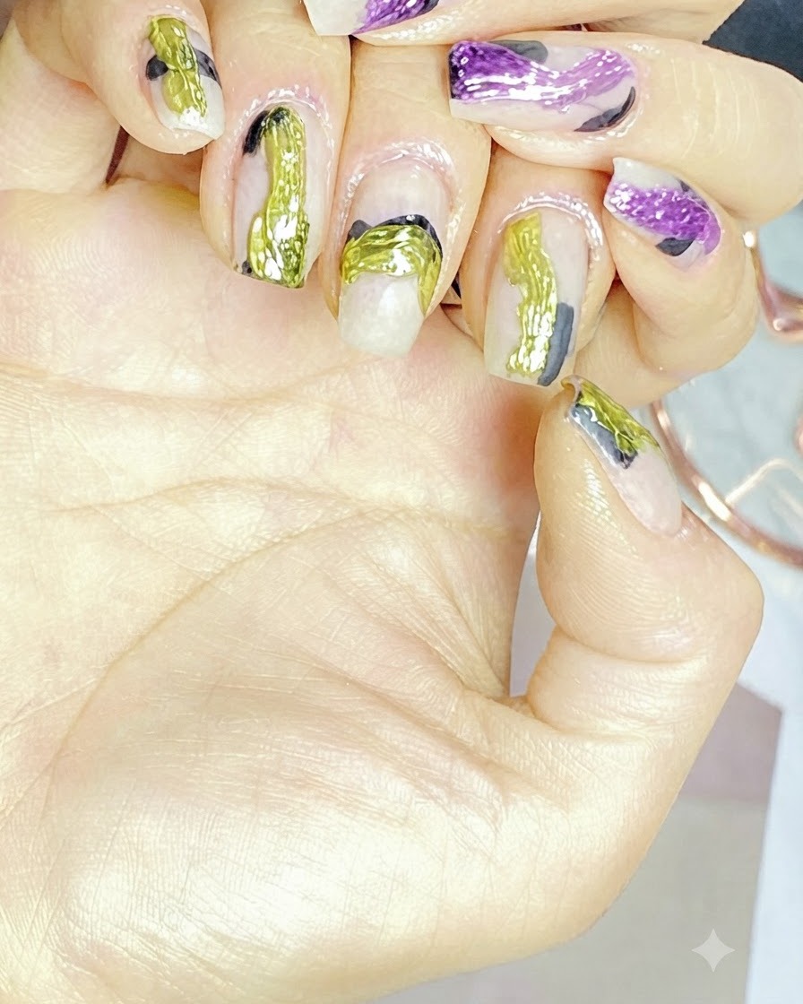 A brush applying a milky translucent nude gel polish onto a cured nail base.
