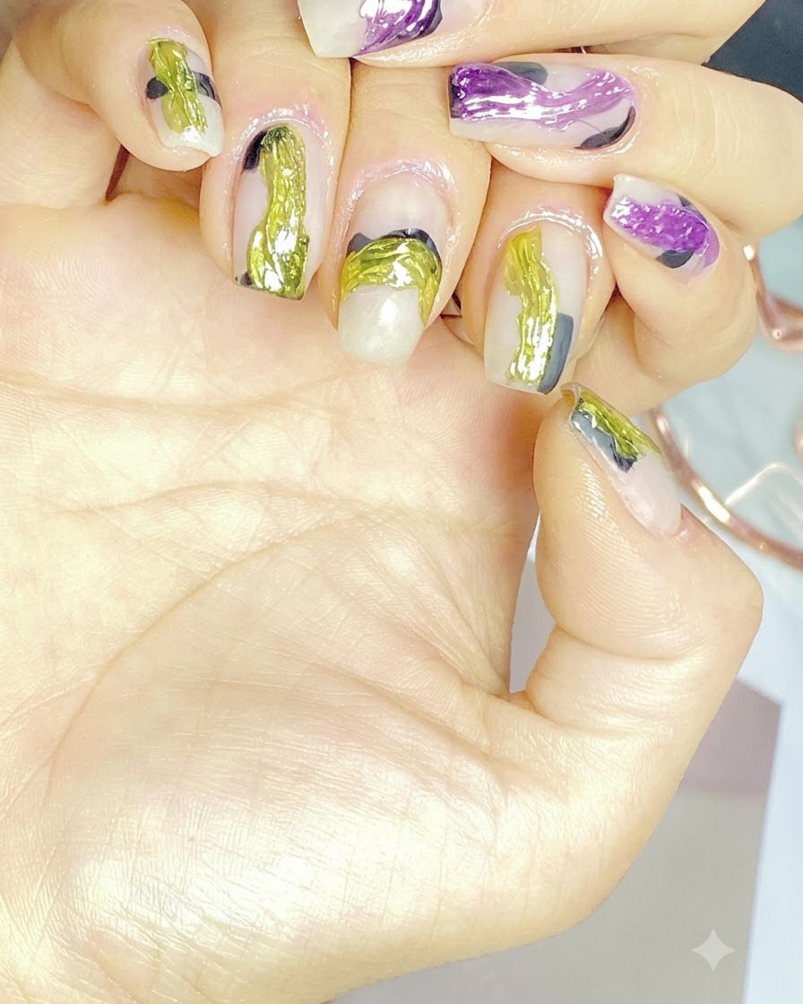 A liner brush carefully painting vibrant purple abstract brush strokes on a nail.