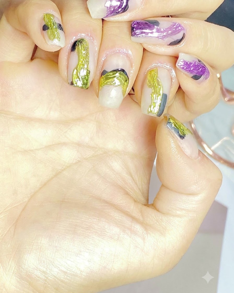 A nail art brush applying striking neon green gel details onto a styled nail.