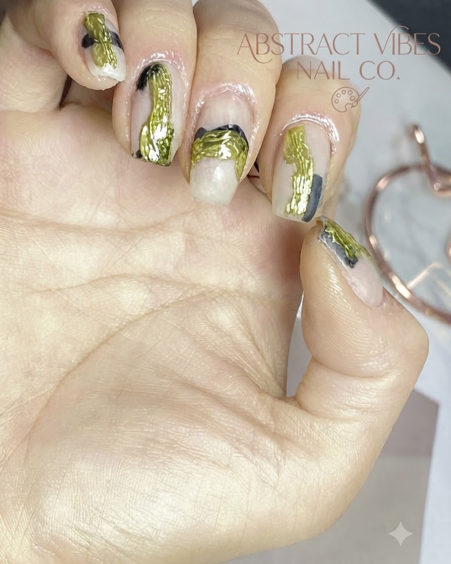 A close-up view of applying metallic foil texture over abstract nail art lines.