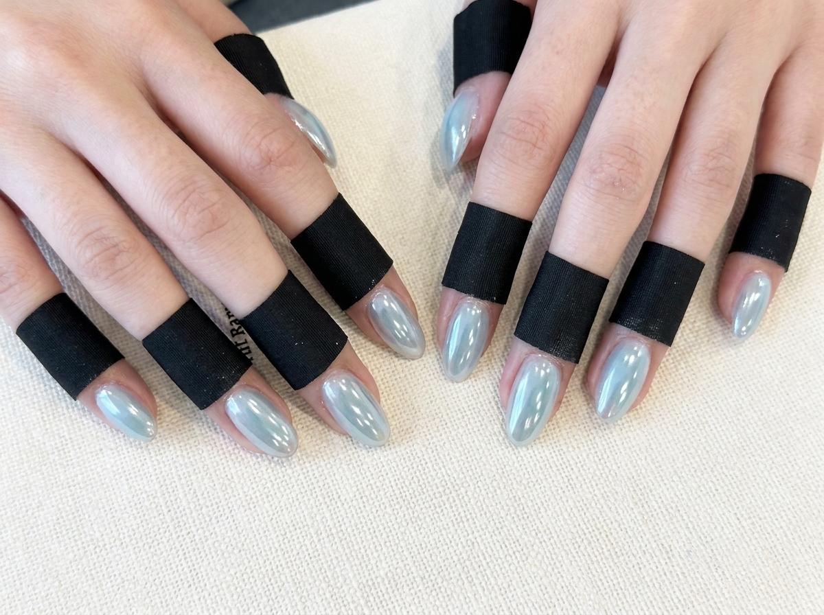 Fingers adjusted slightly to showcase the shimmering dimensional aurora effect under lighting.