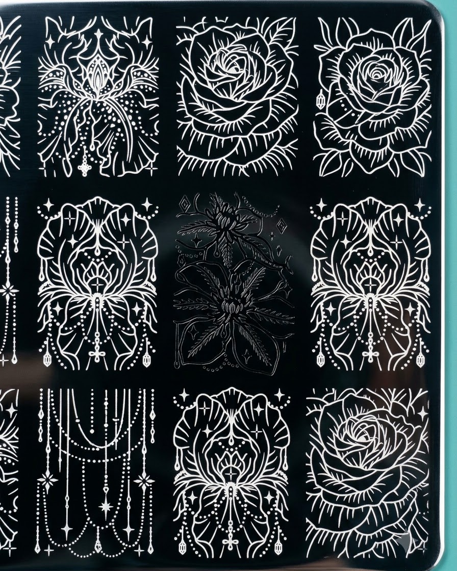 A clear silicone stamper lifting a detailed black floral engraving from a metal stamping plate.