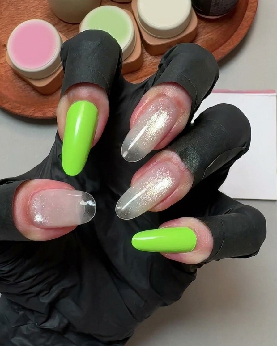 A hand wearing black gloves holding a cleansing pad over cured fake nails.
