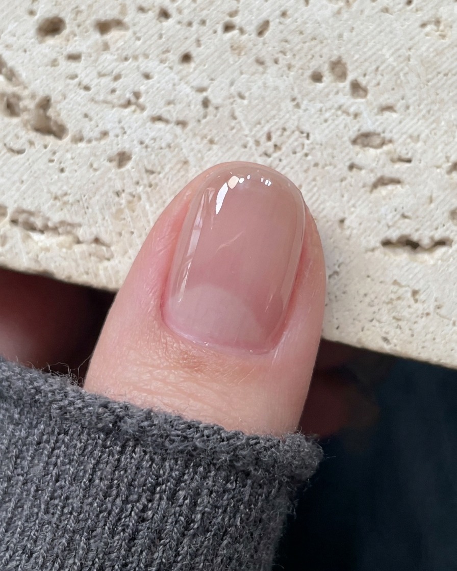 Precision tweezers placing a delicate hollow star sticker onto the center of a cured nail.