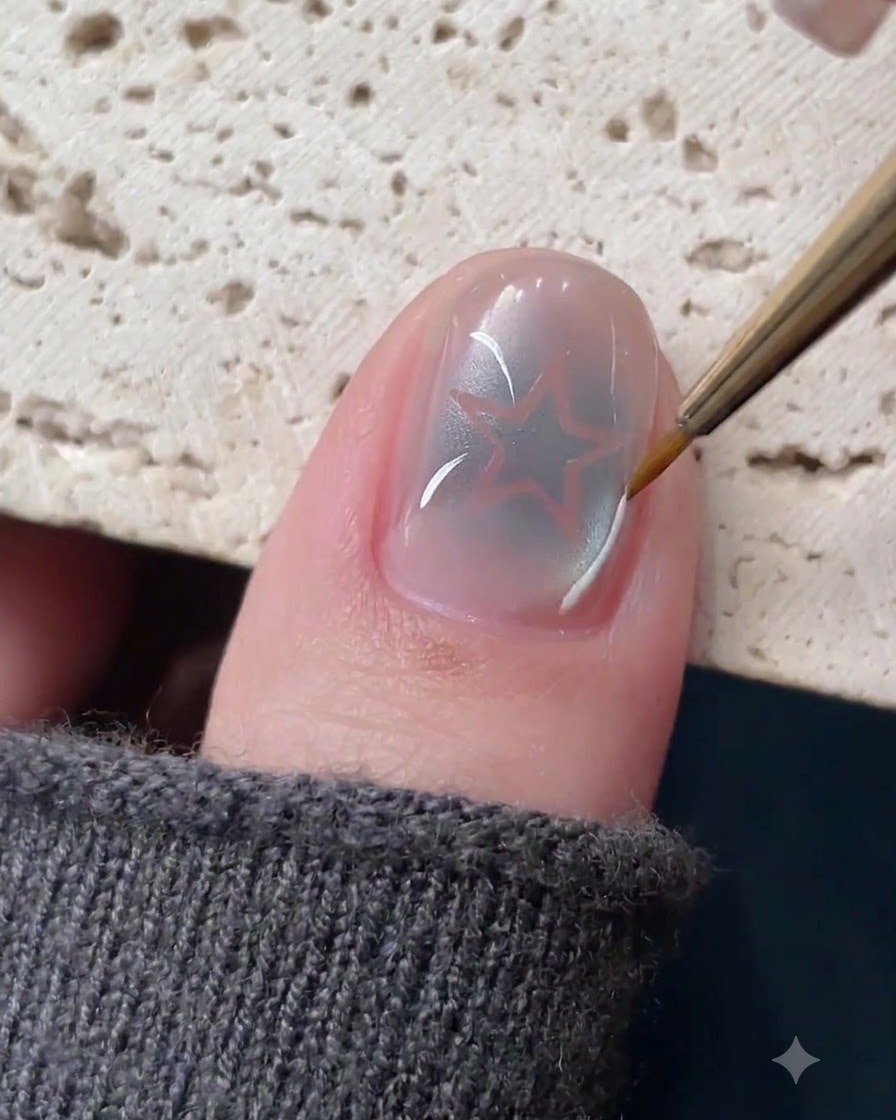A fine liner brush drawing delicate white and silver lines around a hollow star nail design.