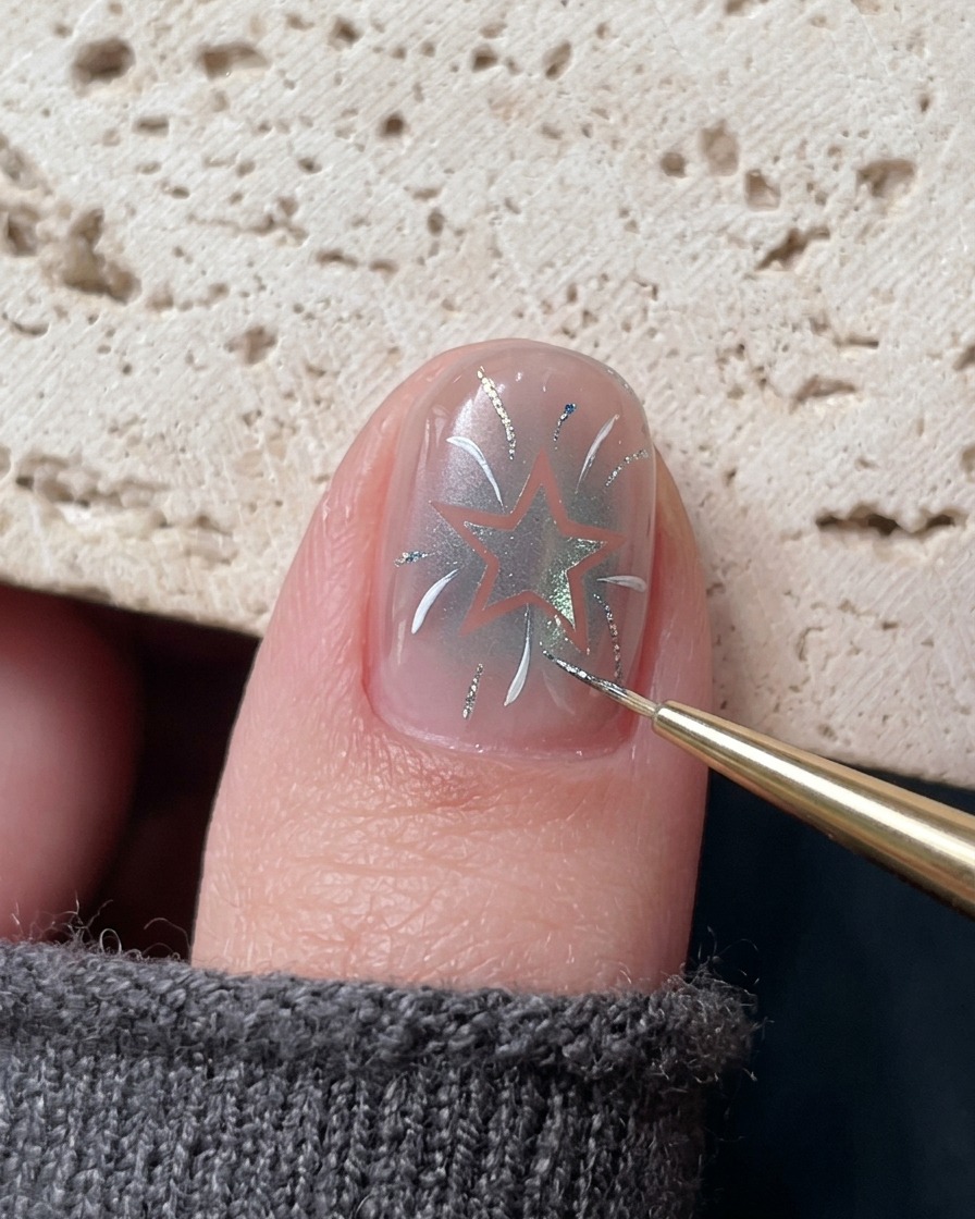 A fine brush applying accents of blue platinum gel onto the detailed nail design.