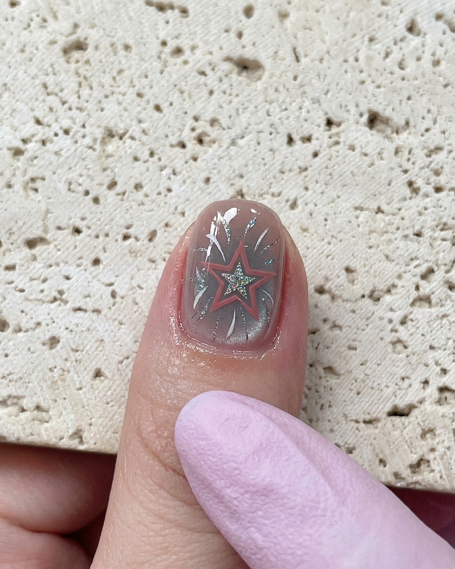 A close-up view showing fingers being massaged with nourishing cuticle oil serum around the joint areas.