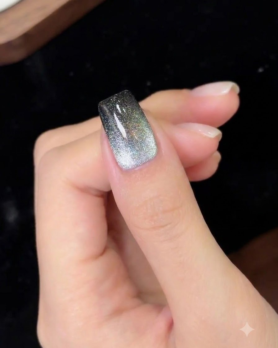 A cured magnetic gradient nail design under lighting.