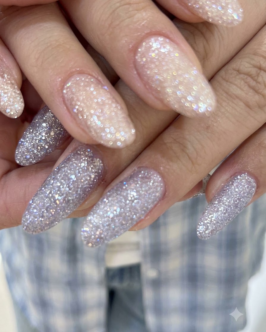 A detailed close-up shot showing translucent crystal sparkle and smooth glitter gel coverage on long nails.