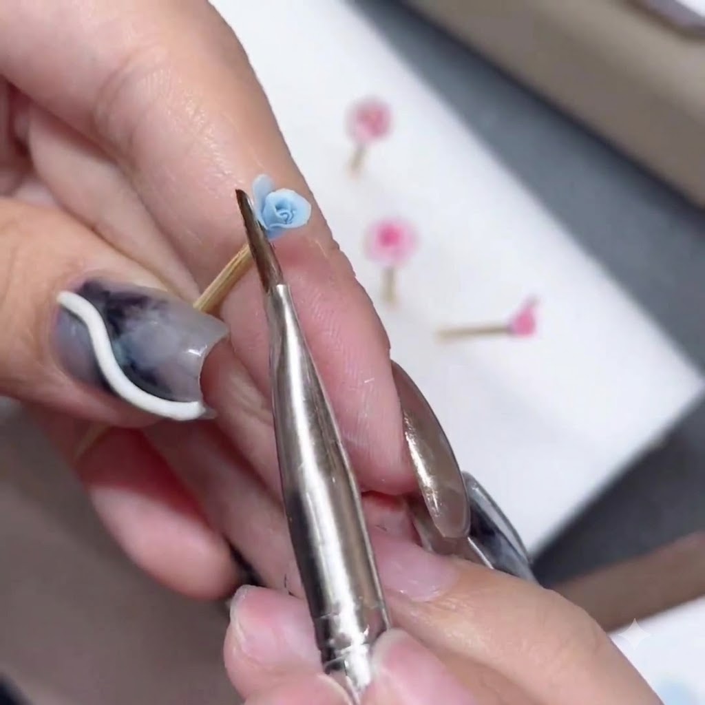 A silicone brush sculpting and flaring the edge of a blue rose petal.