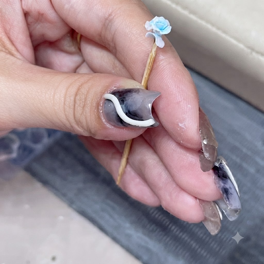 A close-up of a miniature blue rose on a toothpick with a newly attached overlapping petal.