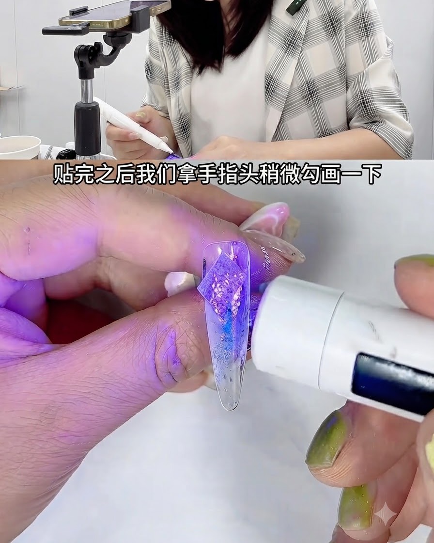 A mini handheld white UV nail lamp shining purple light over a decorated clear practice nail held by a pair of tweezers.
