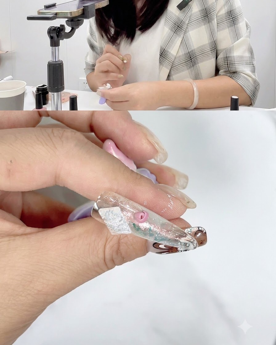 A close-up of a nail with partially completed rose petals curing under a nail lamp.
