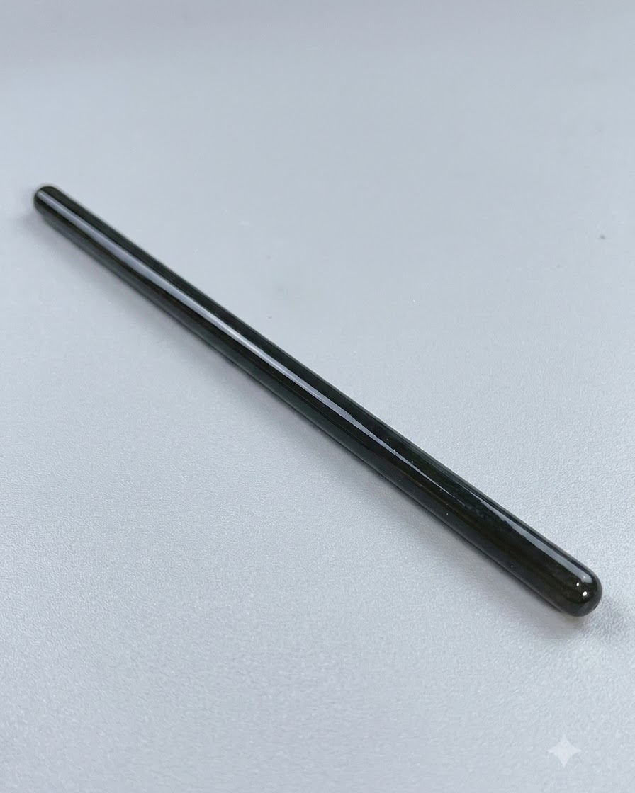 A long fine-tipped nail art brush resting on a clean surface before detailed line work.