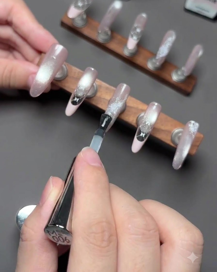 Nails positioned under a UV/LED lamp during the curing process for the reinforcement gel.