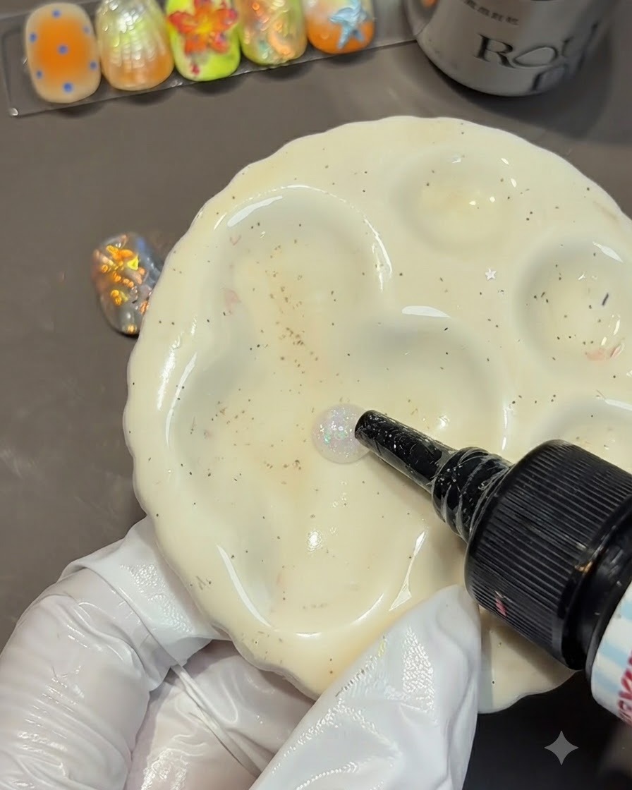 A bottle squeezing a drop of clear mold gel onto a white ceramic palette.