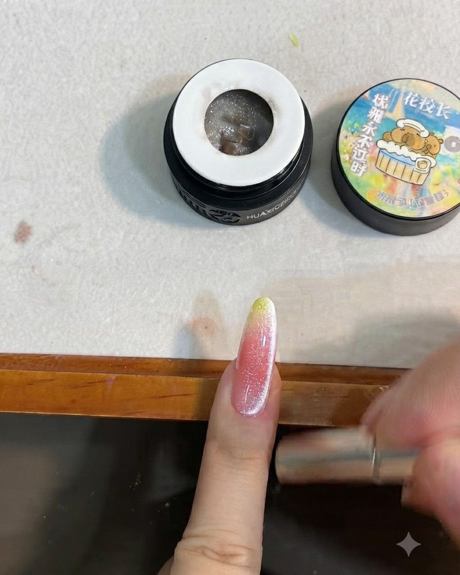 A magnetic tool being used around the sides of a nail to form a cat eye reflection.