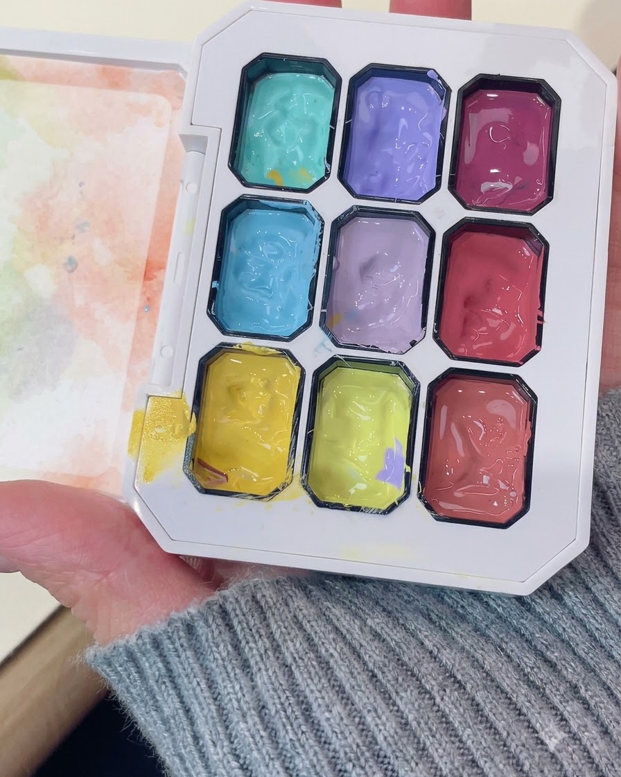 A professional gel palette showing vibrant purple and other colored gel compartments.