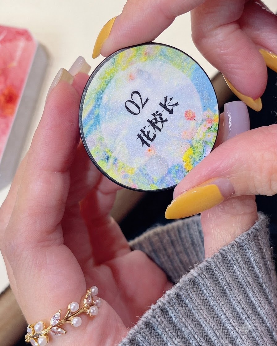 A hand holding a round jar of 02 color gel product labeled with Chinese characters.